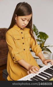 young girl learning how play electronic keyboard home 2
