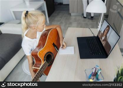 young girl learning how play guitar