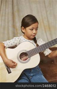 young girl learning how play guitar home 2