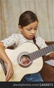young girl learning how play guitar home 4