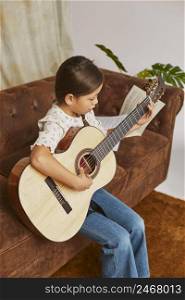 young girl learning how play guitar home 5
