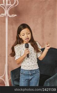 young girl learning how sing home