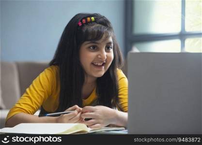Young girl listening carefully to her teacher during online class