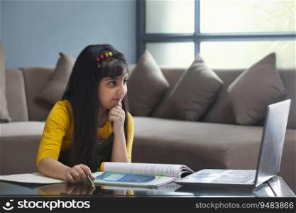 YOUNG GIRL LISTENING TO HER TEACHER IN AN ATTENTIVE MANNER