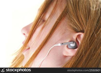 Young girl listening to music on her mp3 player