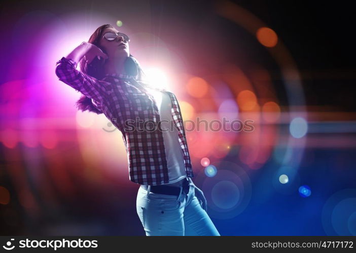 Young girl listens to music. Young girl listens to music. Modulations of color and light.