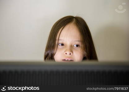 Young girl looking at computer screen