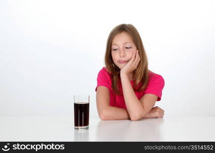 Young girl looking at glass of soft drink
