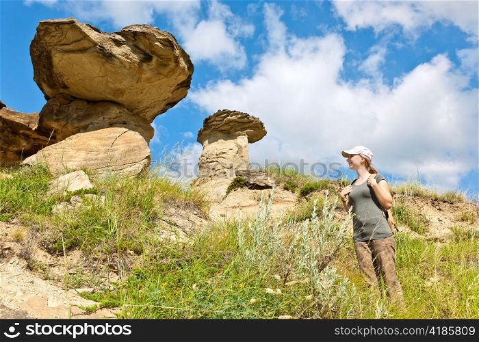 Young girl looking at hoodoos in badlands of Dinosaur provincial park, Alberta, Canada