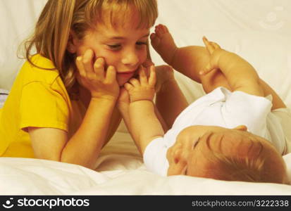 Young Girl Looking at new Sibling