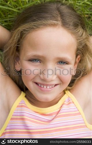 Young Girl Lying Down On The Grass