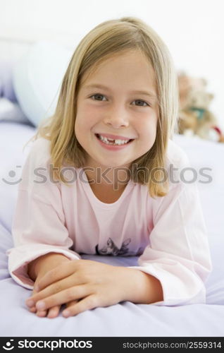 Young Girl Lying On Her Bed In Her Pajamas