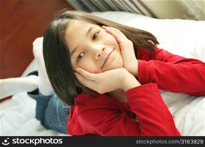Young girl lying on the bed