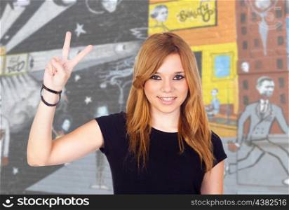 Young Girl Making a Victory Sign With a Painted Wall of Background