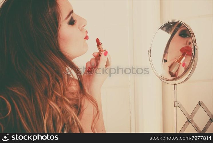Young girl making makeup. Pretty girl making makeup in bathroom. Woman take care about look. Looking into a mirror. Giving kiss. Retro style