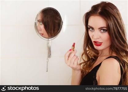 Young girl making makeup. Young girl making makeup in bathroom. Woman take care about look.