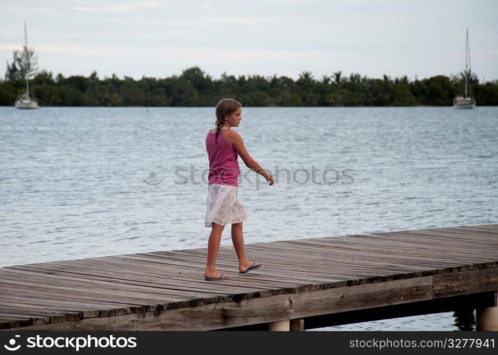 Young girl on a pier at Placencia in Belize