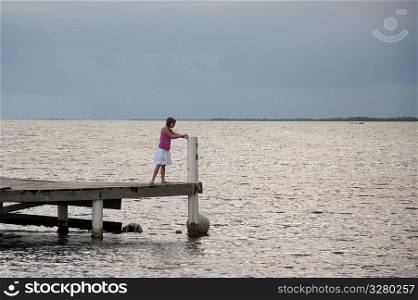 Young girl on a pier at Placencia in Belize