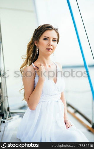 young girl on deck of sailing wooden white yacht