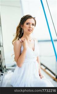 young girl on deck of sailing wooden white yacht