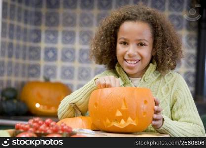 Young girl on Halloween with jack o lantern smiling