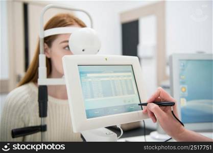 young girl patient on reception at doctor ophthalmologist. diagnostic ophthalmologic equipment. medicine concept. equipment in the eye clinic
