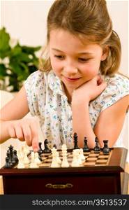 Young girl play chess cute smile alone at home