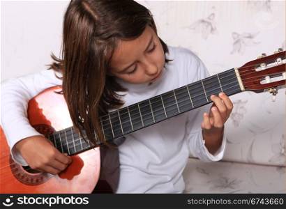 Young girl play classical guitar