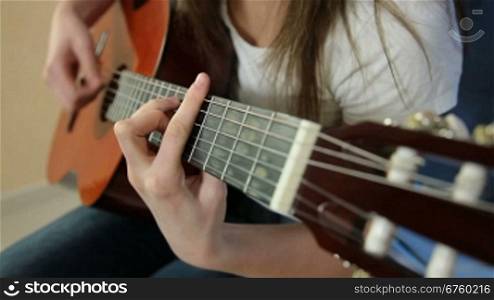 Young Girl Playing Guitar Close-up