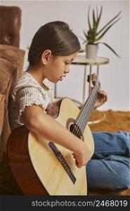 young girl playing guitar home 3