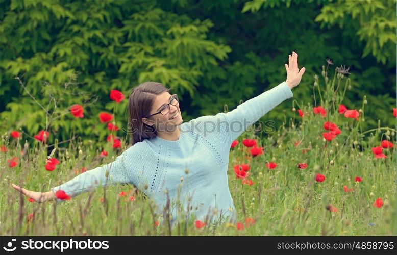 Young girl playing in a poppy field