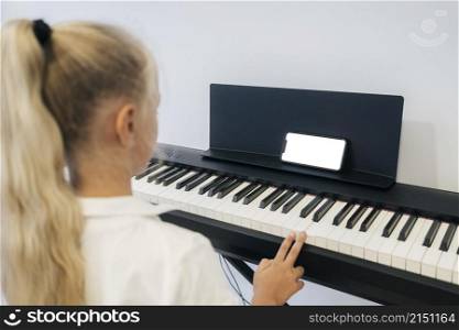 young girl playing keyboard instrument