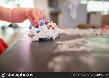 Young girl playing messy play at table