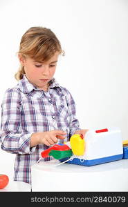 Young girl playing with a toy till