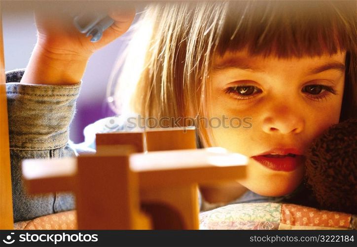 Young Girl Playing with Blocks