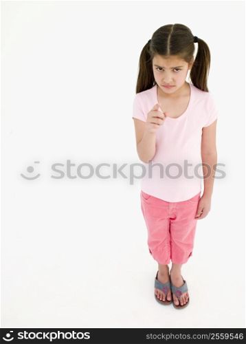 Young girl pointing and frowning