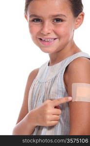 Young girl pointing to a plaster