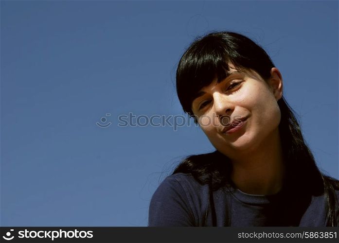 young girl portrait with the sky as background