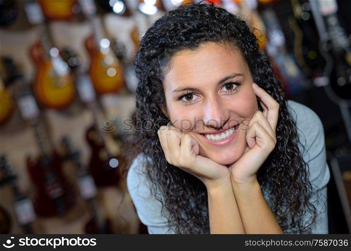 young girl posing in the guitar shop