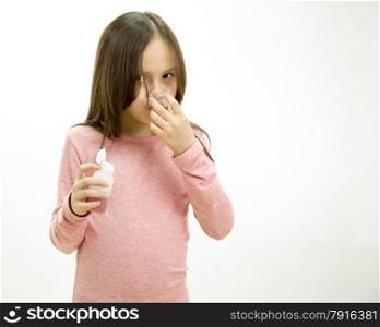 Young girl pouring and taking medicine