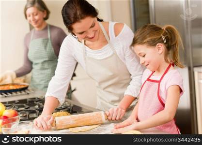 Young girl prepare apple pie baking with mother and grandmother