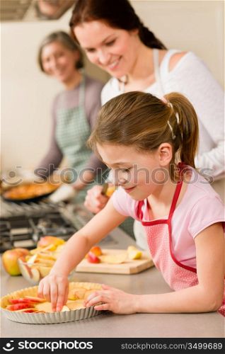 Young girl prepare apple tart baking with mother and grandmother