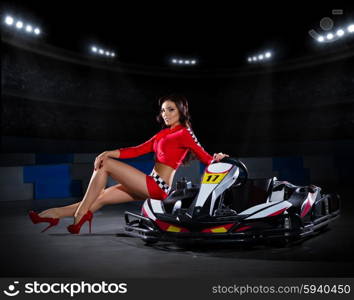 Young girl racer with kart at stadium