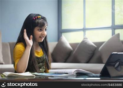 Young girl raising her hand during attendance in her online class 