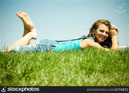 Young girl relaxing on a meadow