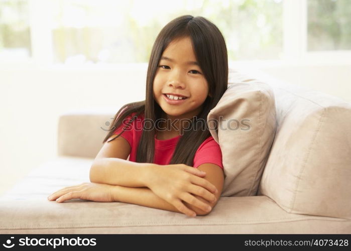 Young Girl Relaxing On Sofa At Home