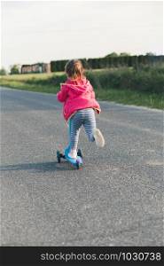 Young girl riding on roller skates. Real people, authentic situations