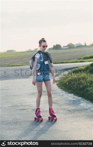 Young girl riding on roller skates. Real people, authentic situations
