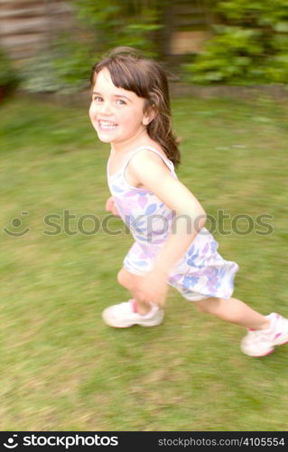 young girl running while looking at camera