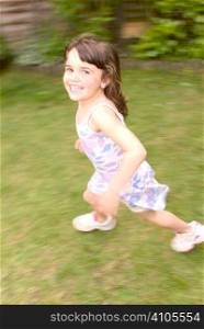 young girl running while looking at camera